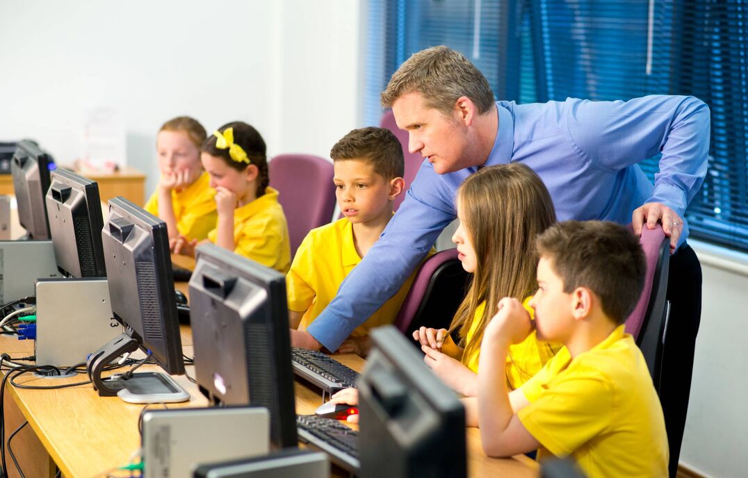 students in yellow uniform in computer lab
