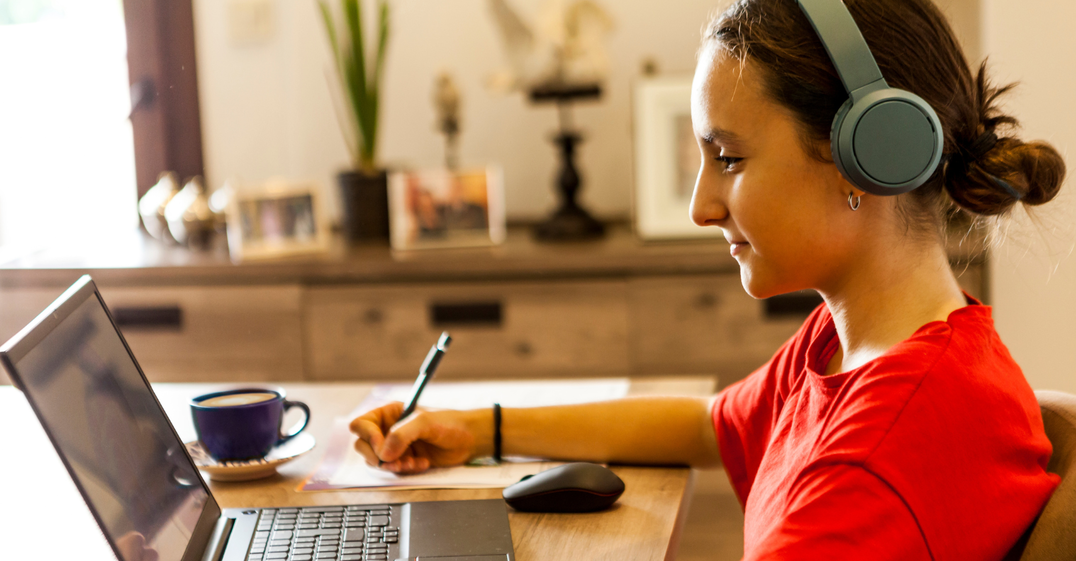 Girl on laptop wearing headphones