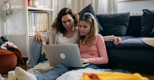 Mother and daughter looking at laptop